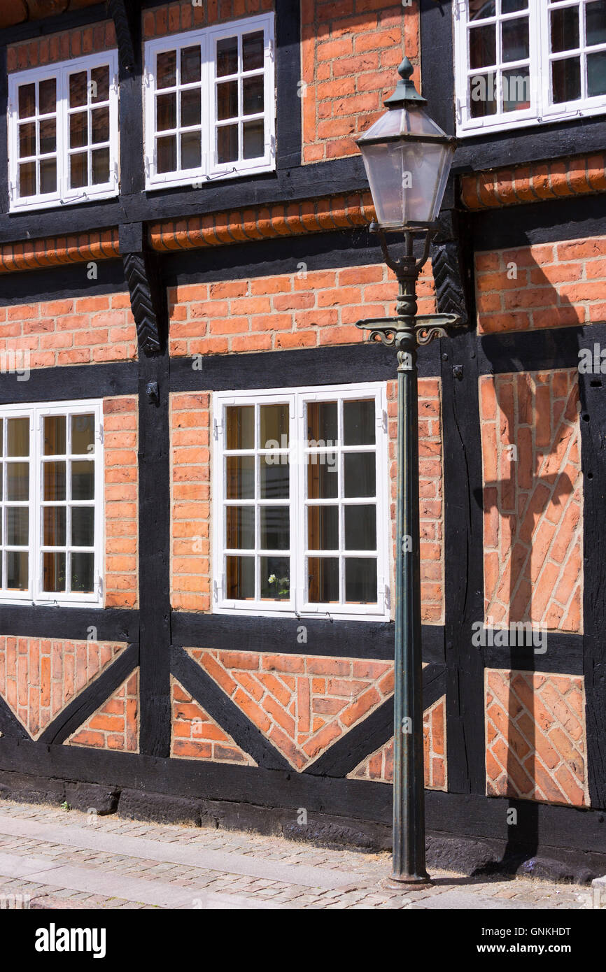 Old fashioned street lamp light and half-timbered house in Ribe centre, South Jutland, Denmark Stock Photo