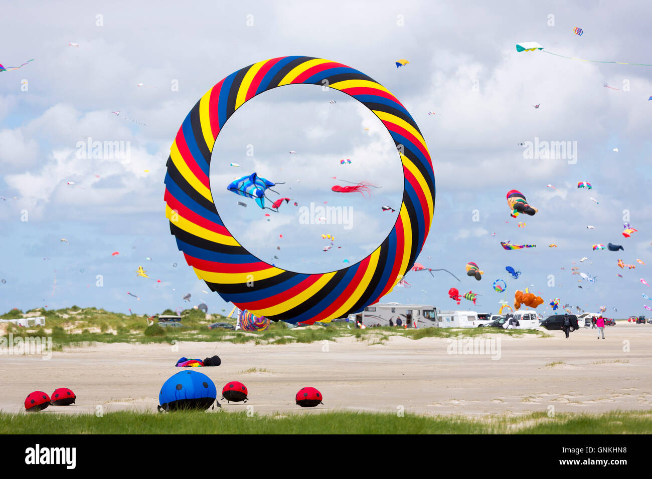 Kite festival of bright color kites in the sky above Rindby Strand beach on Fano Island - Fanoe - South Jutland, Denmark Stock Photo