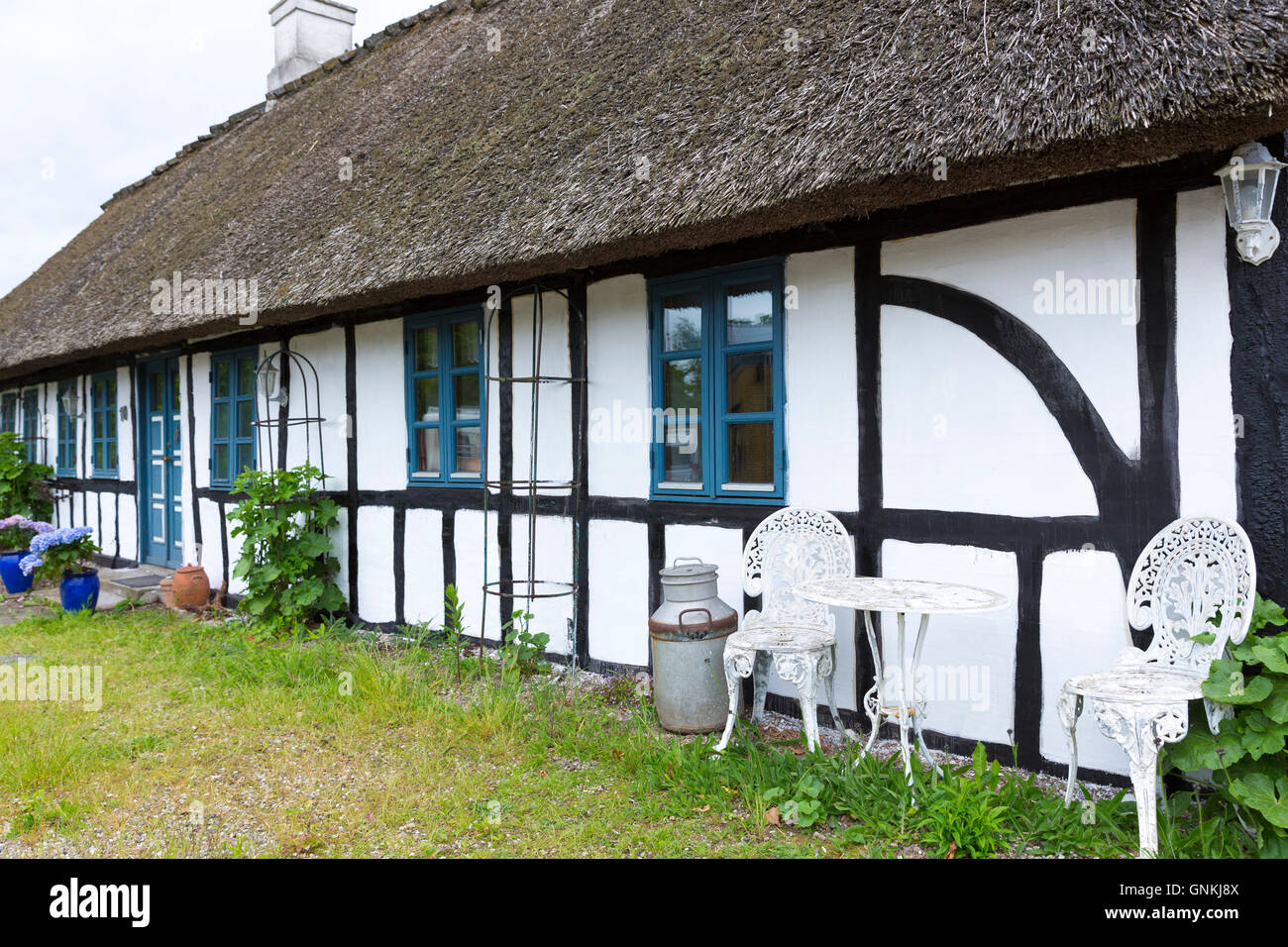 Quaint old half-timbered thatched cottage home on the island of Funen, Denmark Stock Photo