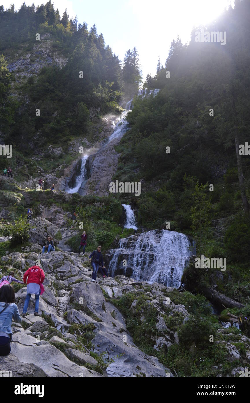 Tourists in front of Horses' Waterfall, the tallest in Romania Stock Photo