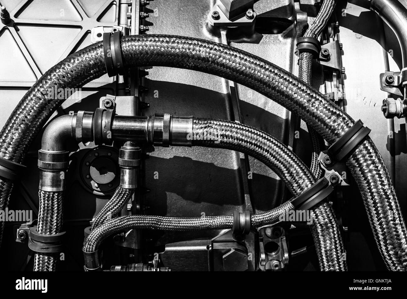 Fragment of modern technology. Details of engine pipelines. Black and white. Background. Stock Photo