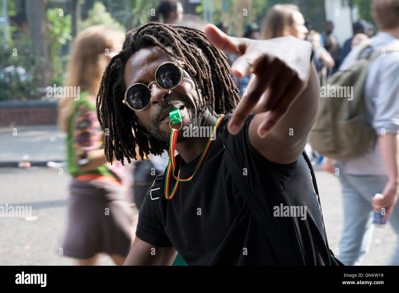 Portrait of a man blowing a whistle at Notting Hill Carnival in London Stock Photo