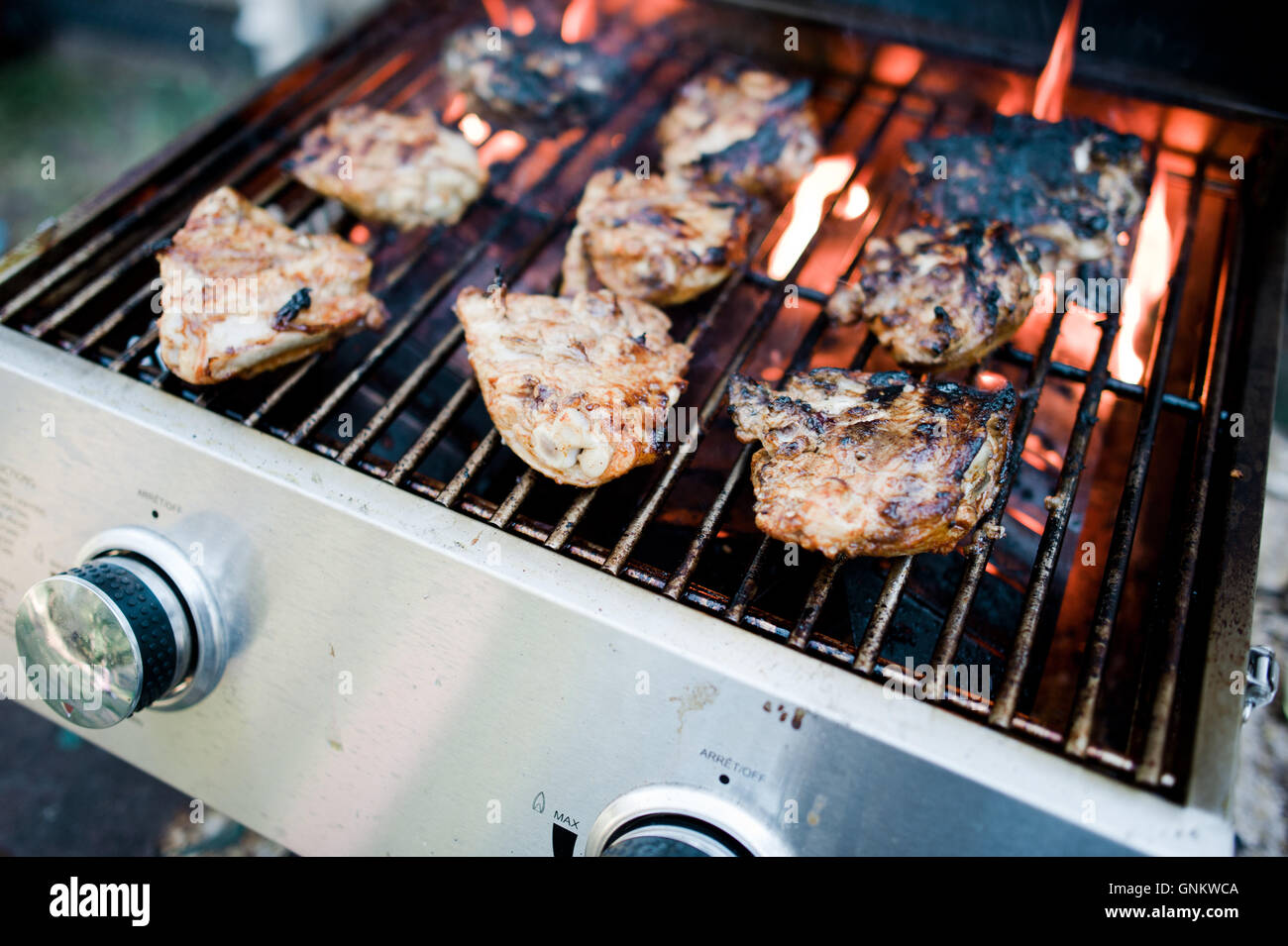 Chicken thighs cooking on barbecue Stock Photo Alamy