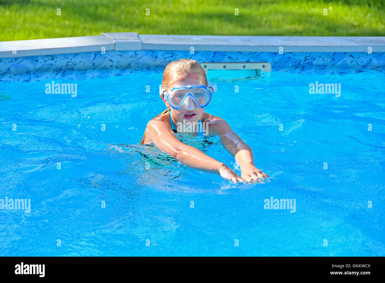 Little girl in pool with swim goggles Stock Photo Alamy