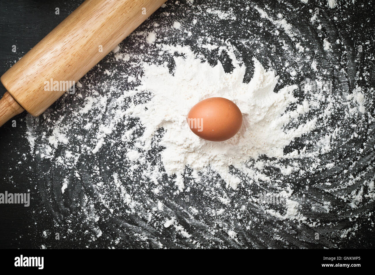 Galaxy on the Kitchen. Spiral of galaxy spelled by wheat flour and brown chicken egg on chalkboard Stock Photo