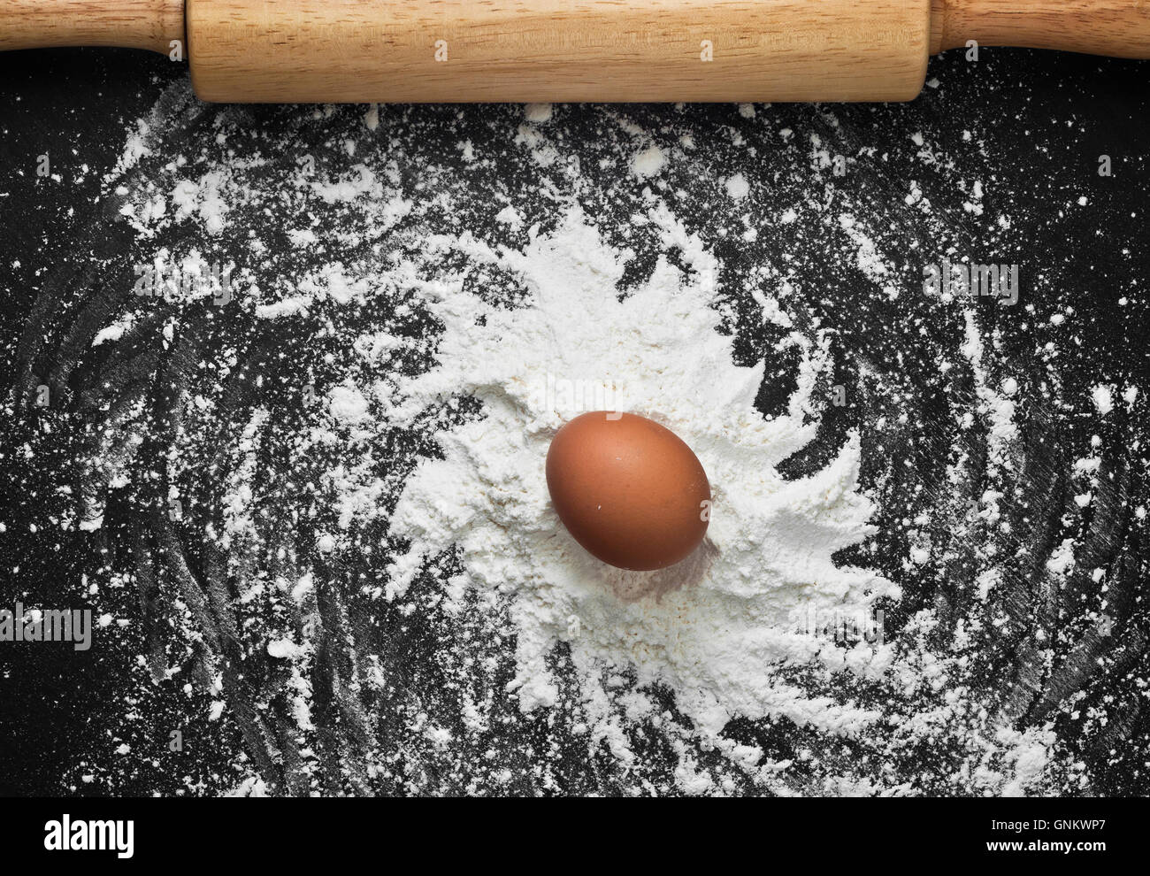 Galaxy on the Kitchen. Spiral of galaxy spelled by wheat flour and brown chicken egg on chalkboard Stock Photo