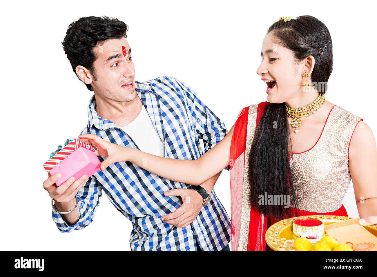 2 indian Teenagers Brother and Sister Raksha Bandhan Festivals Snatching gift Stock Photo