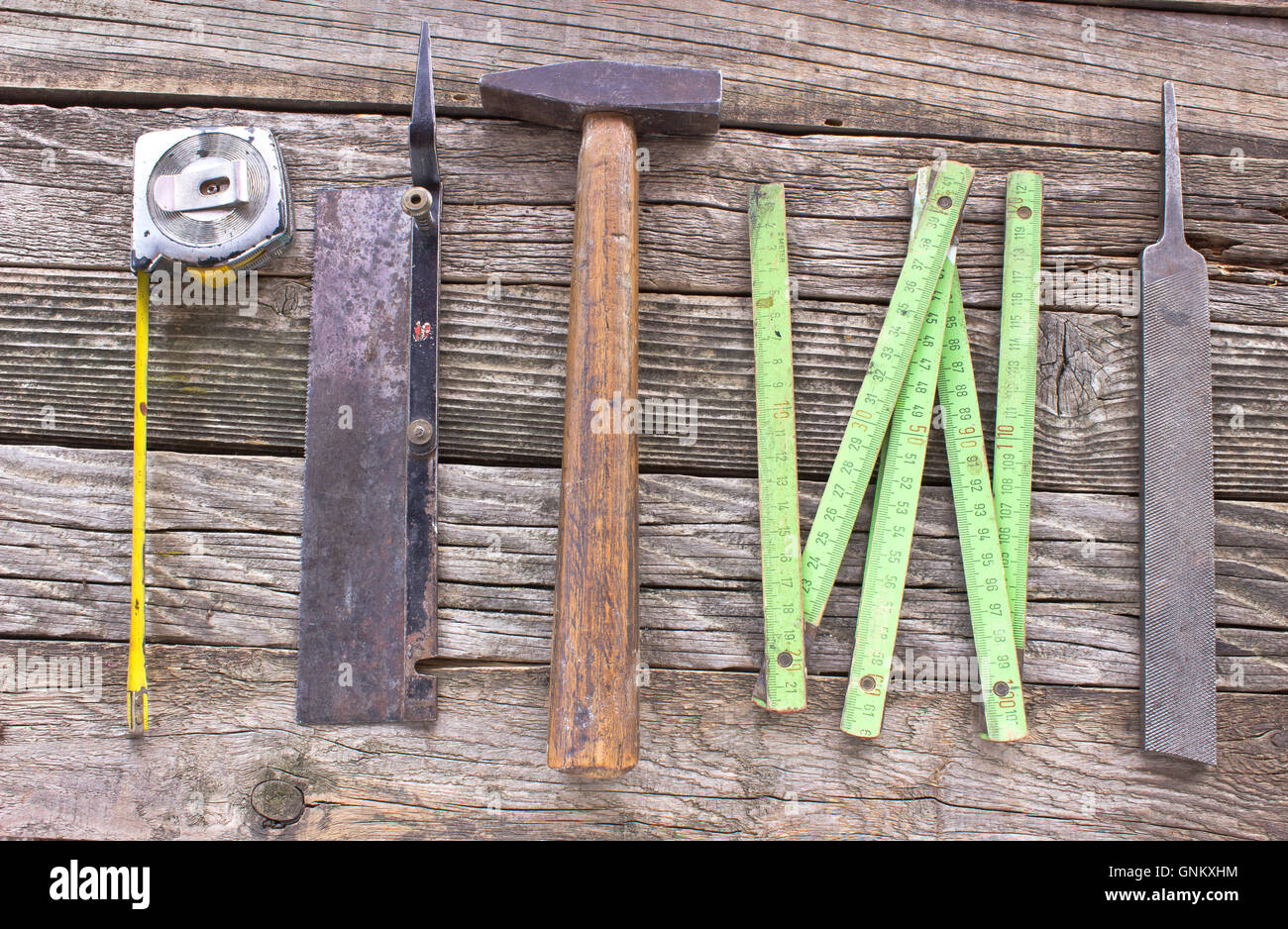 Old used carpentry tools on wooden background Stock Photo