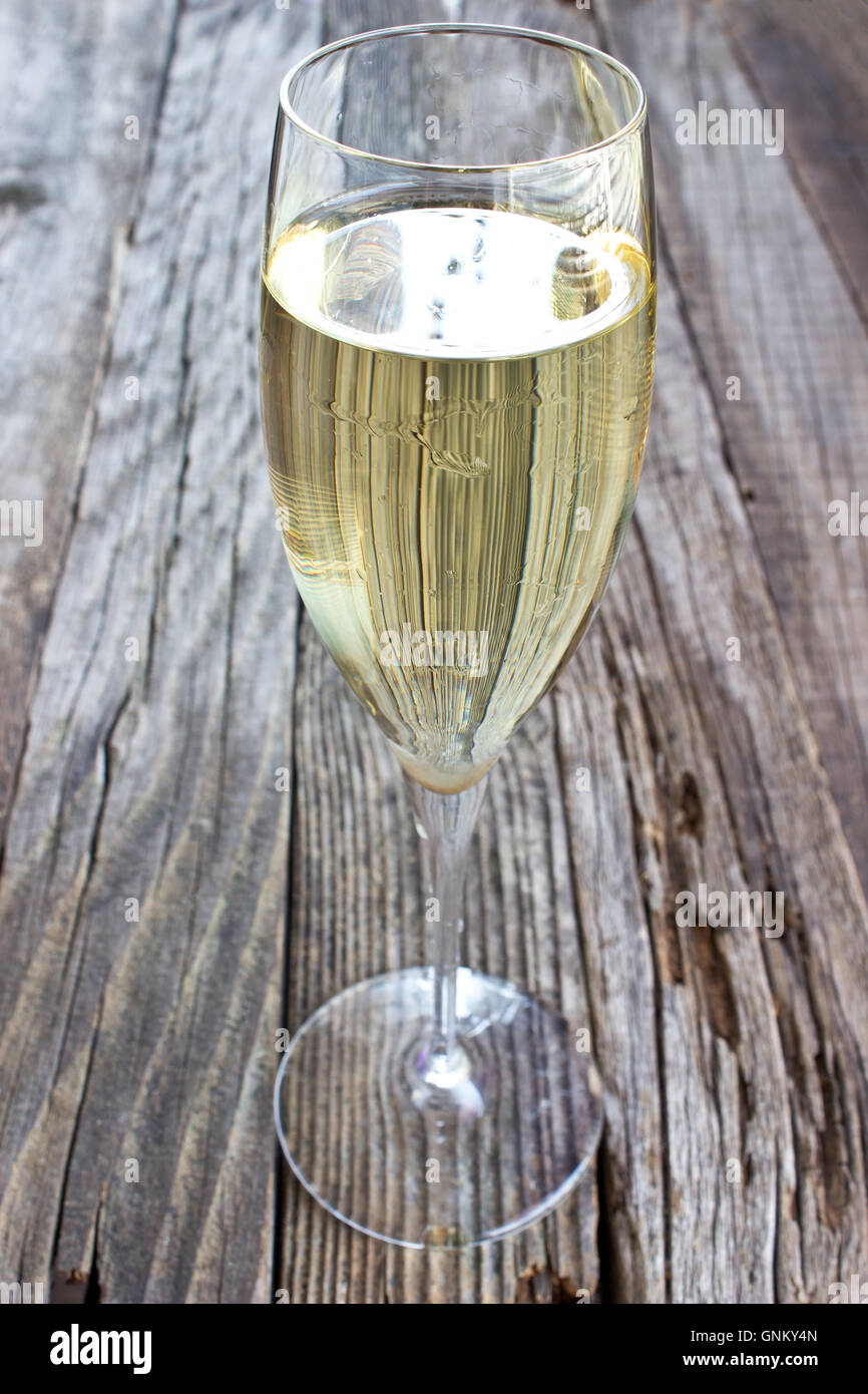Glass of white wine on vintage wooden table Stock Photo