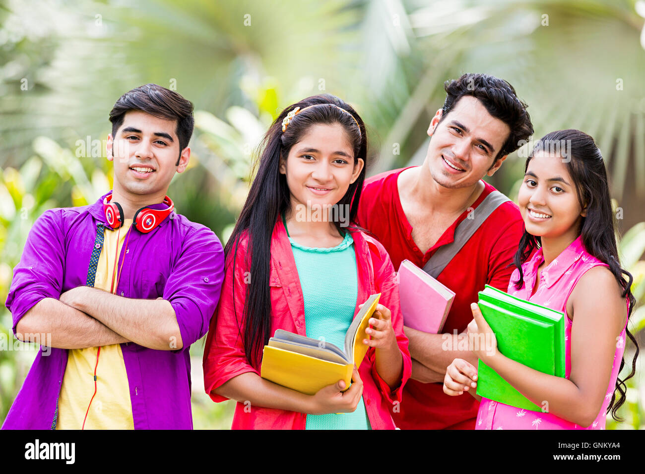 5 Young Girls and Boys Friends College Student Park Standing  Book Studying Stock Photo