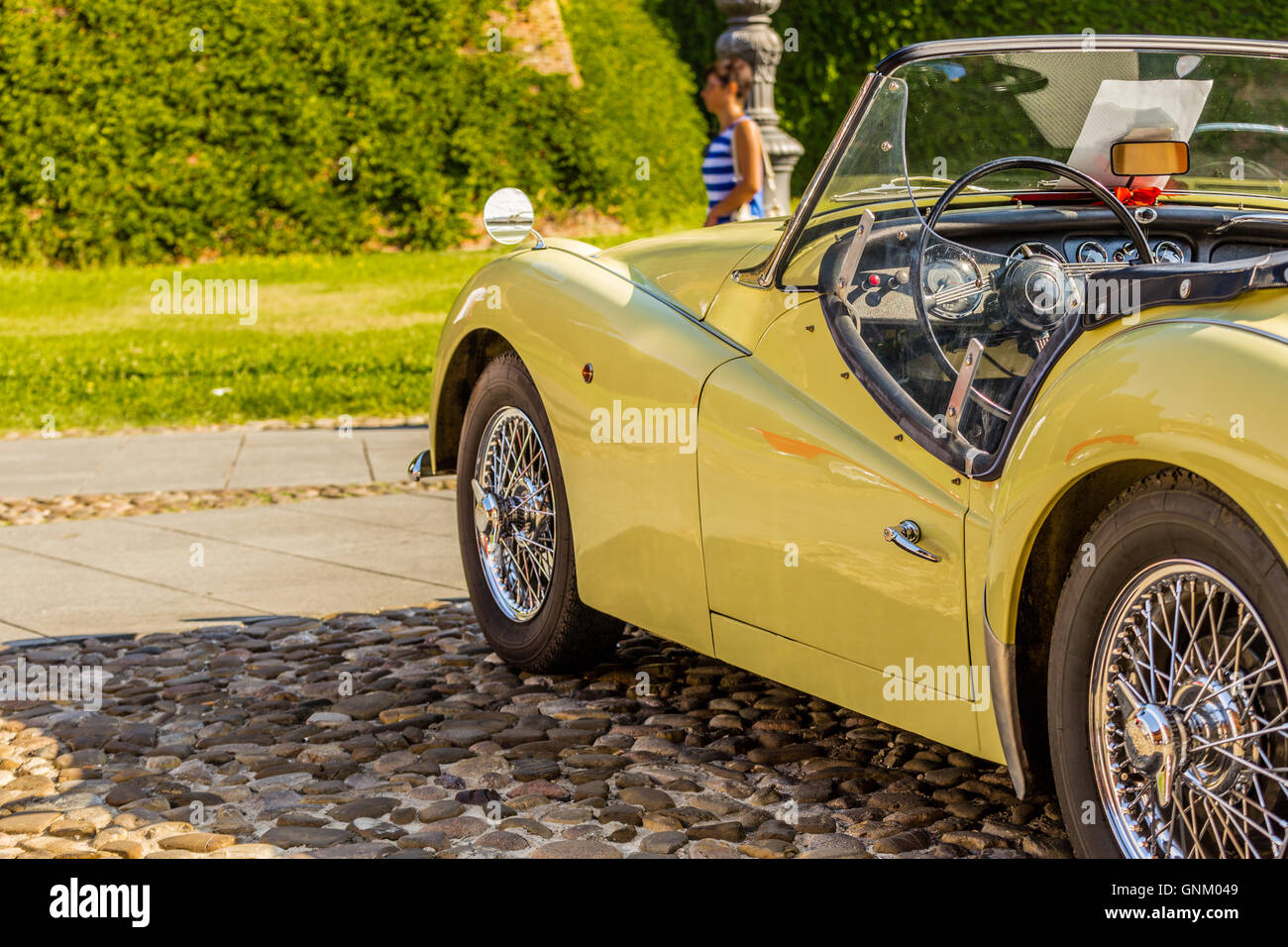 view from behind of the sinuous side line of the bodywork of yellow vintage convertible car Stock Photo
