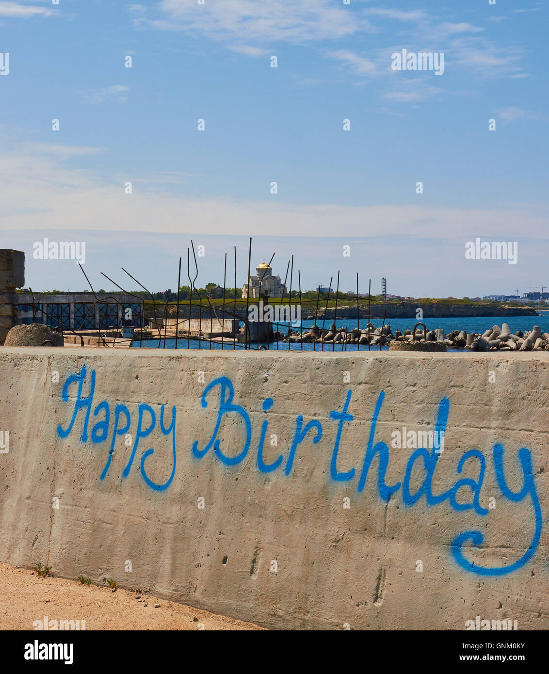 Happy Birthday graffiti on jetty by the Black Sea with St Vladimir's Cathedral on the horizon Sevastopol Crimea Stock Photo
