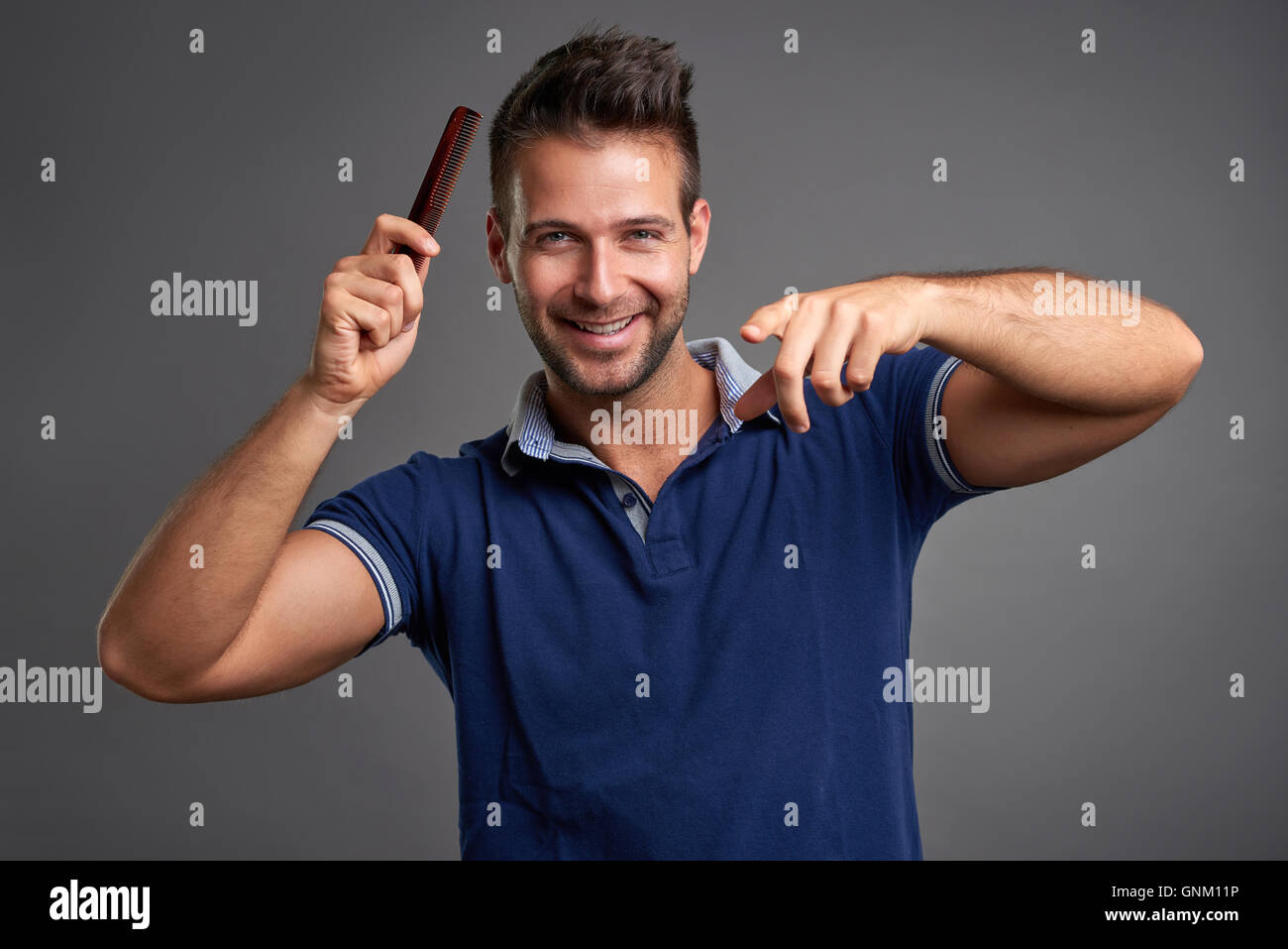 Smiling unshaven man pointing hi-res stock photography and images - Alamy