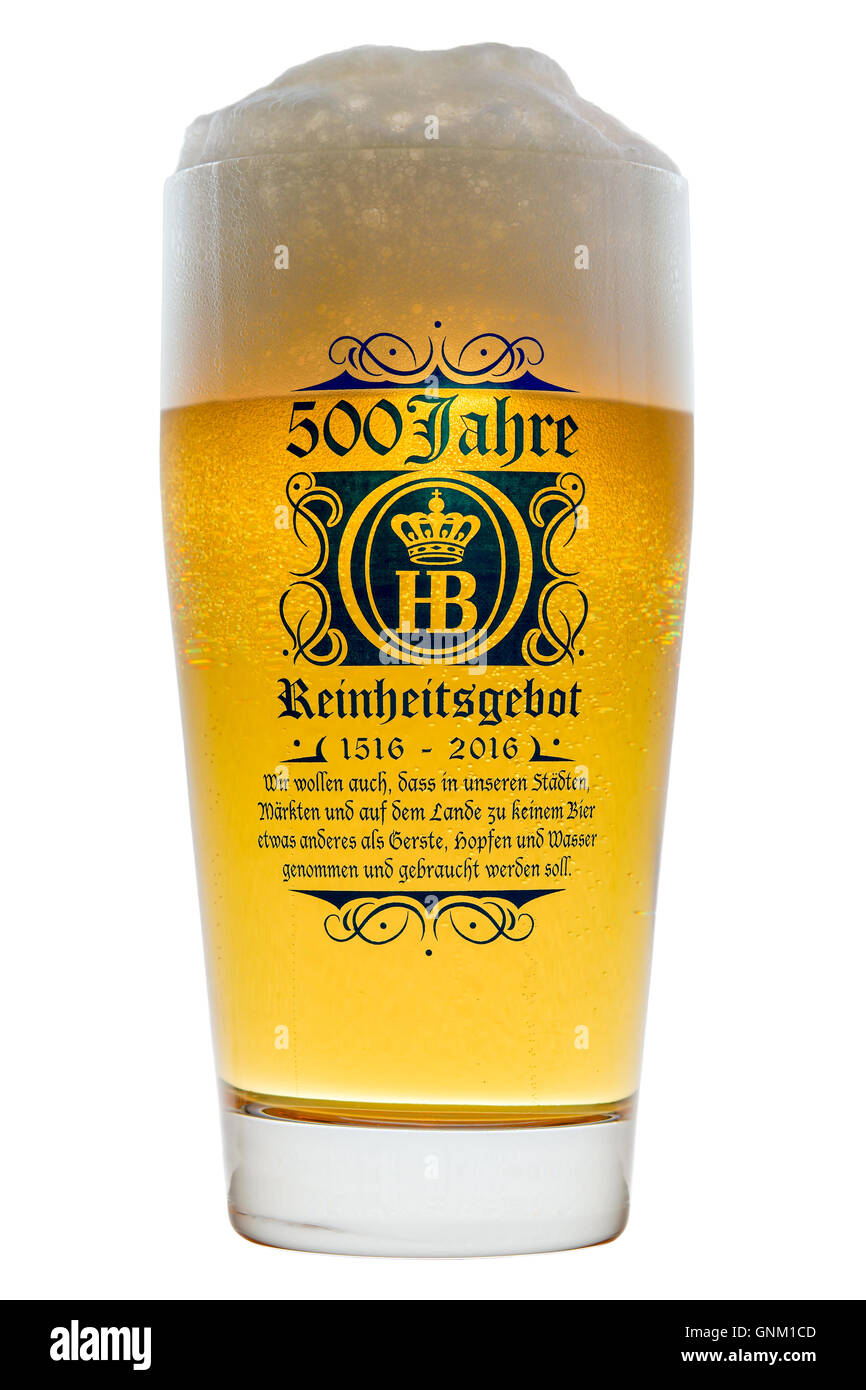 Glass of cold Bavarian beer with frothy foam head backlit isolated on white with text 500 years of Reinheitsgebot Stock Photo