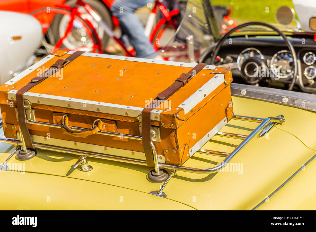 old leather suitcase on the luggage rack of yellow vintage car Stock ...