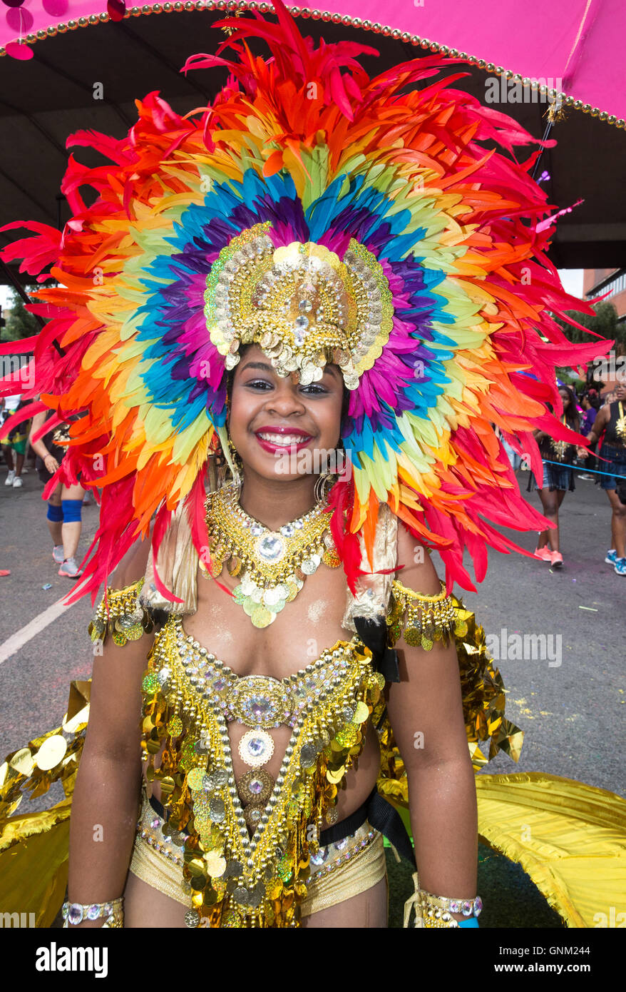 A festival performer in traditional costume parading at the Notting Hill carnival in West London Stock Photo