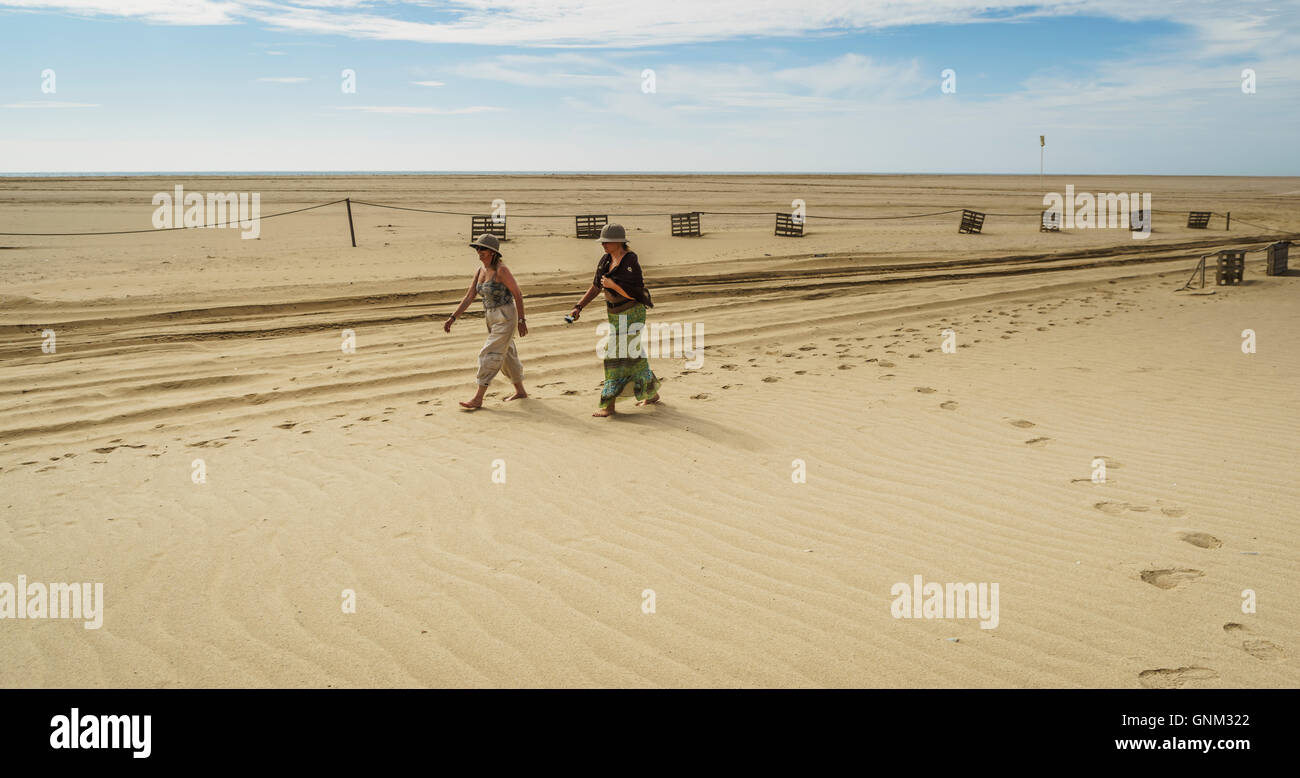 Woman walking on the sand, Pelican Point Lodge, Walvis Bay, Namibia, Africa Stock Photo