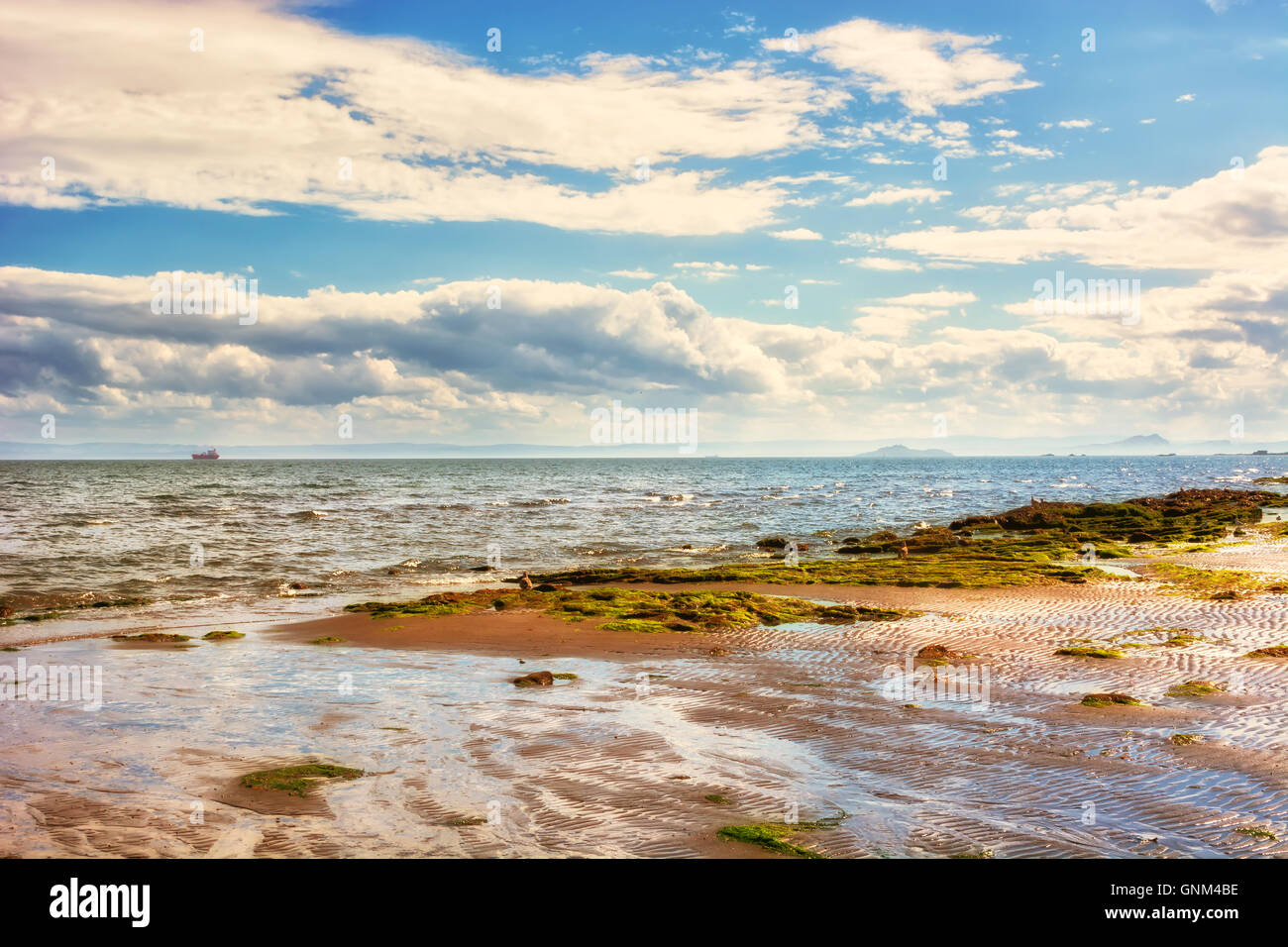 Coastal landscape at low tide in Scotland, UK. The town of Kirkcaldy