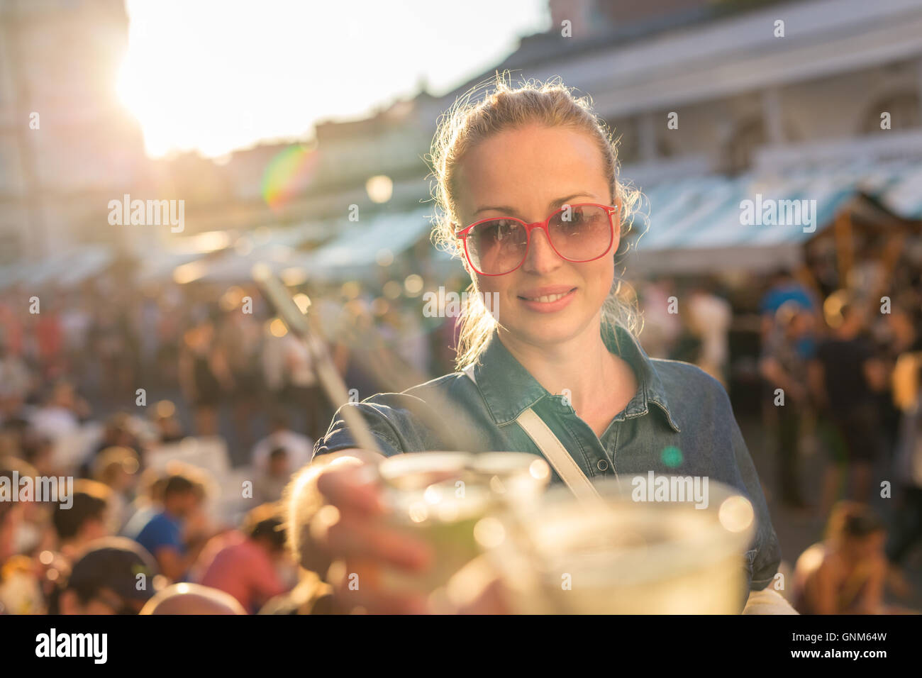 Beautiful young girl toasting on outdoor urban event Stock Photo Alamy