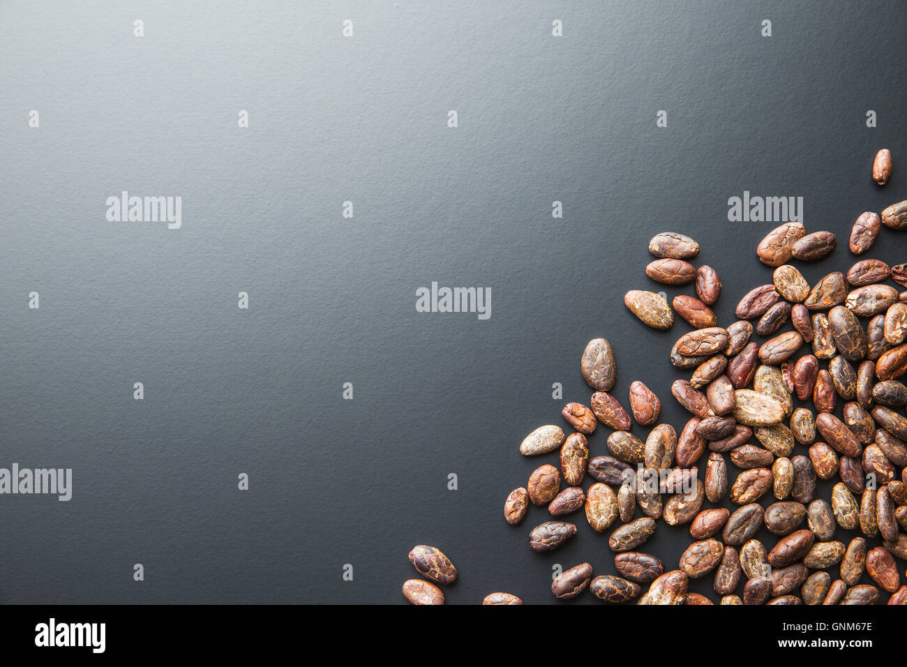 The roasted cocoa beans on black background Stock Photo - Alamy
