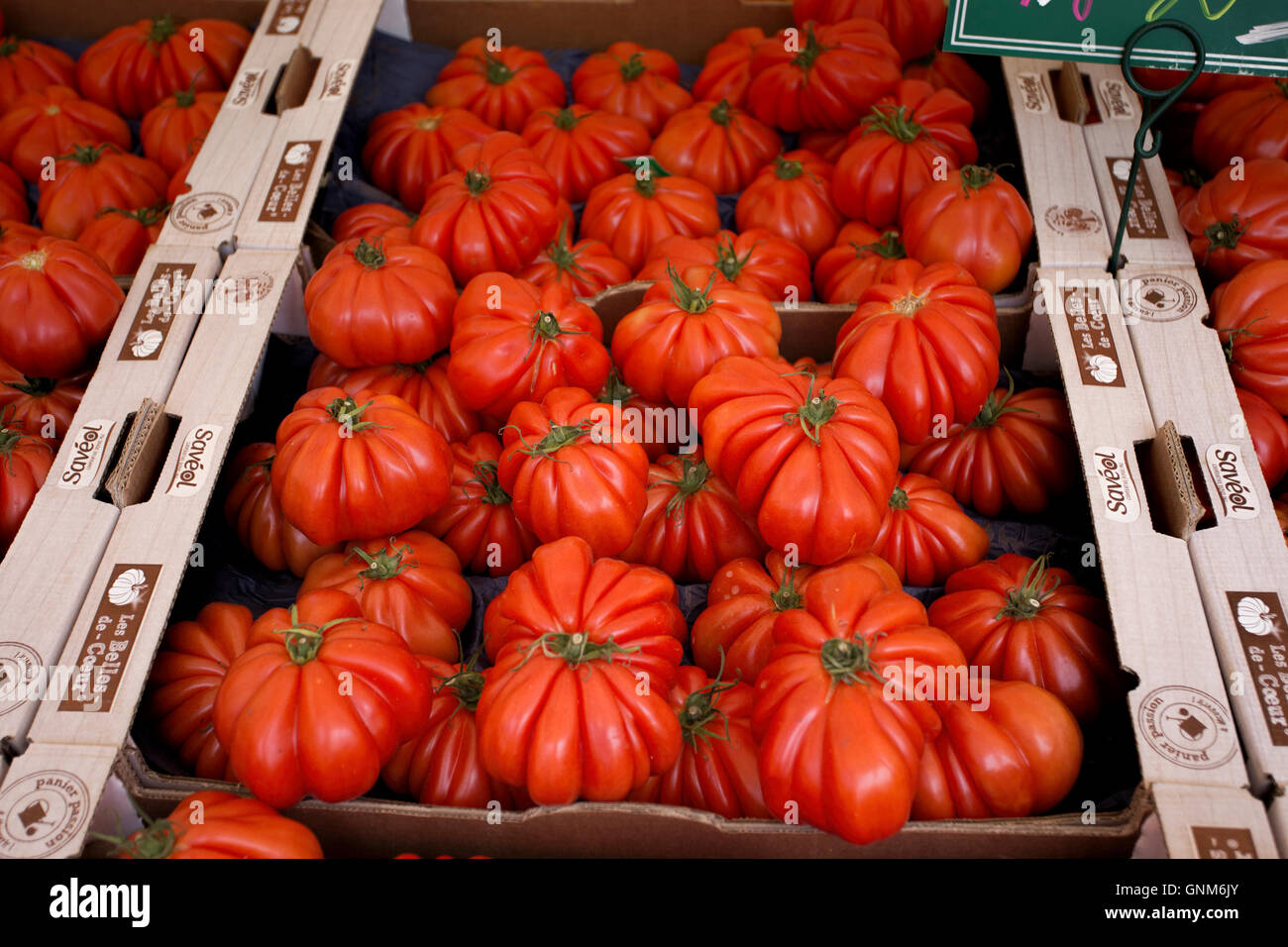 Boxes of large Oxheart tomatoes on a French market stall Stock Photo