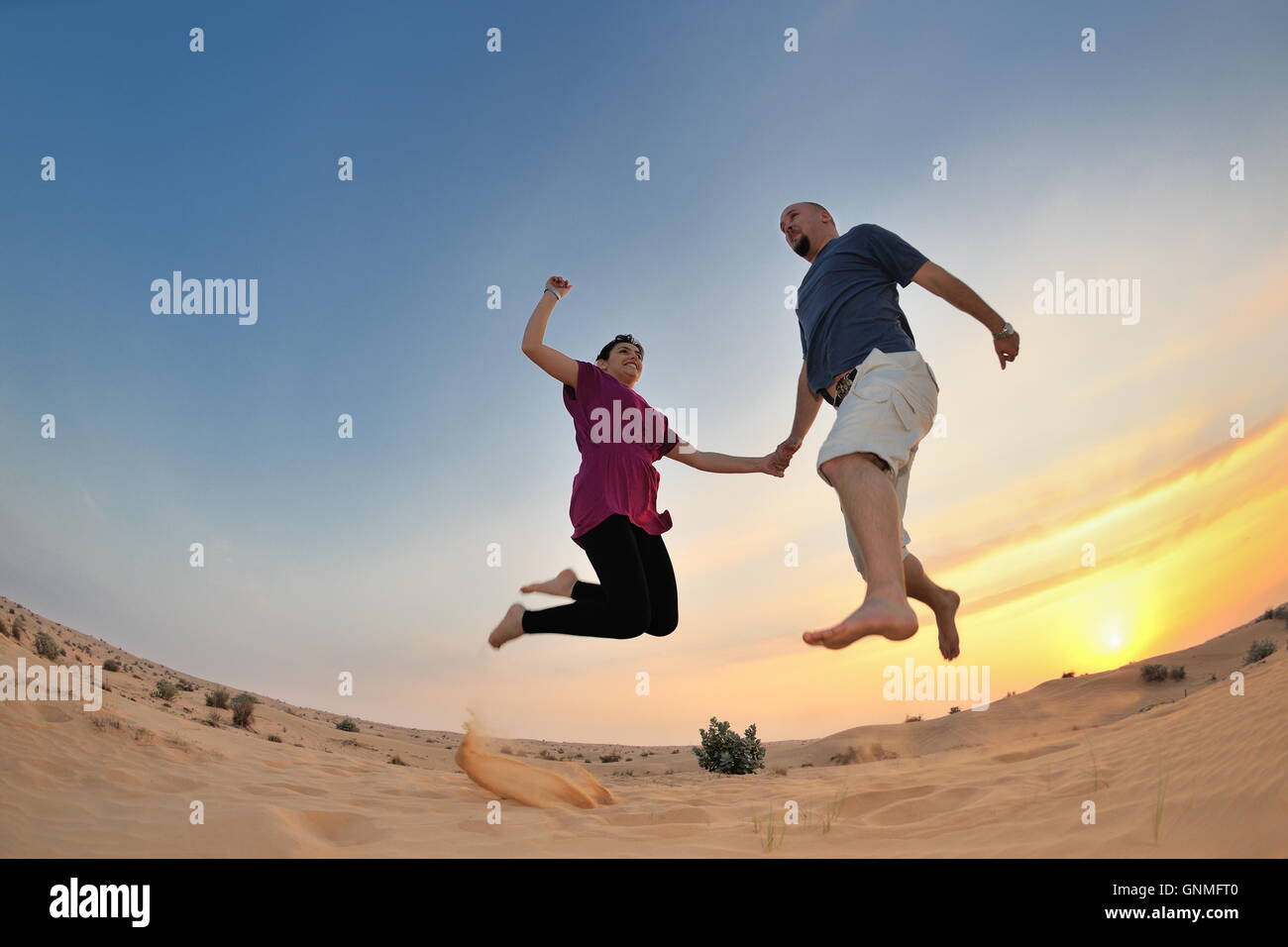 couple enjoying the sunset Stock Photo - Alamy