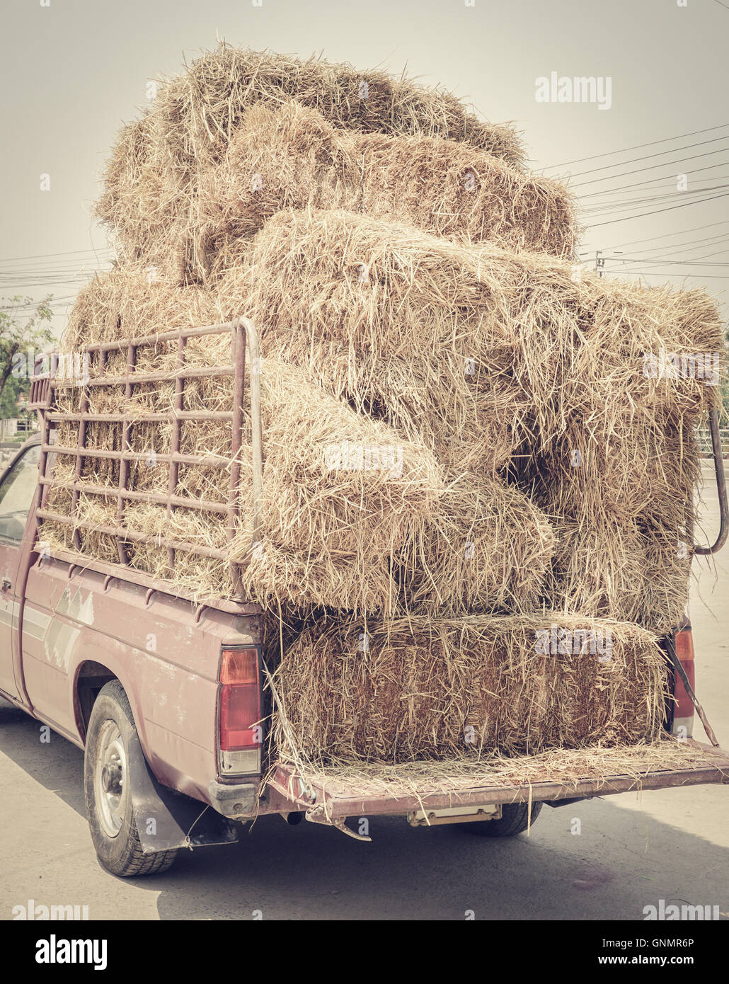 Dried yellow hay or haystack on old truck, colored filter effect Stock Photo