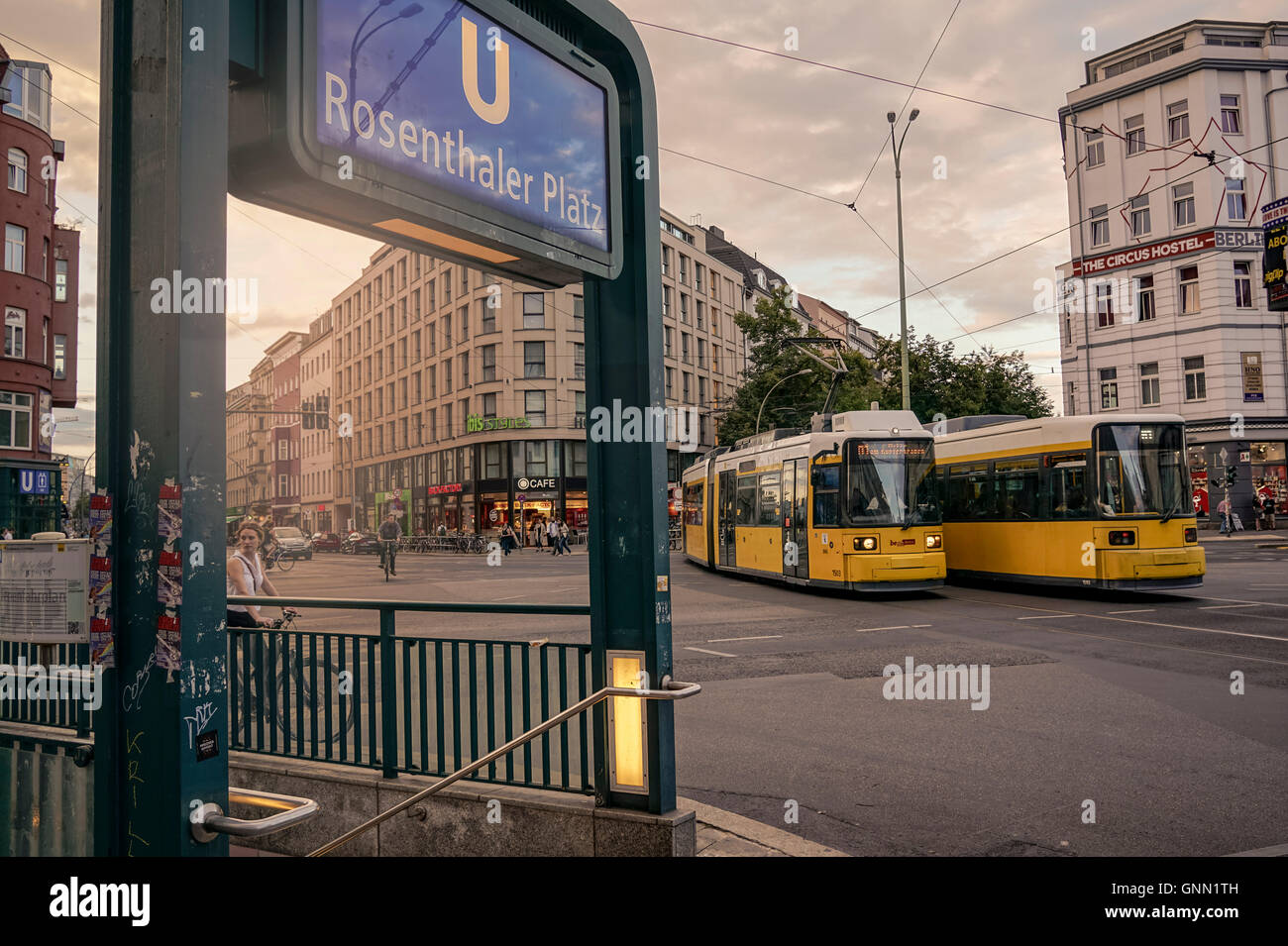 Intersection Rosenthaler Platz with two tram trains meeting each other at sunset Stock Photo