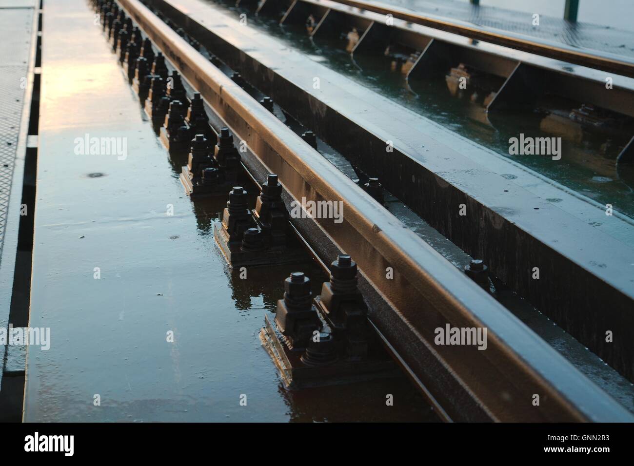 Wet rails detail Stock Photo - Alamy