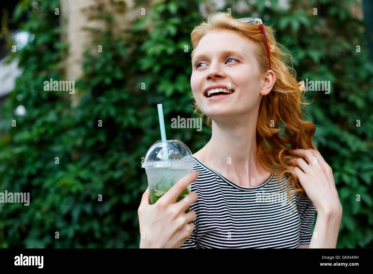 Outdoors portrait of cheerful caucasian girl with drink Stock Photo - Alamy