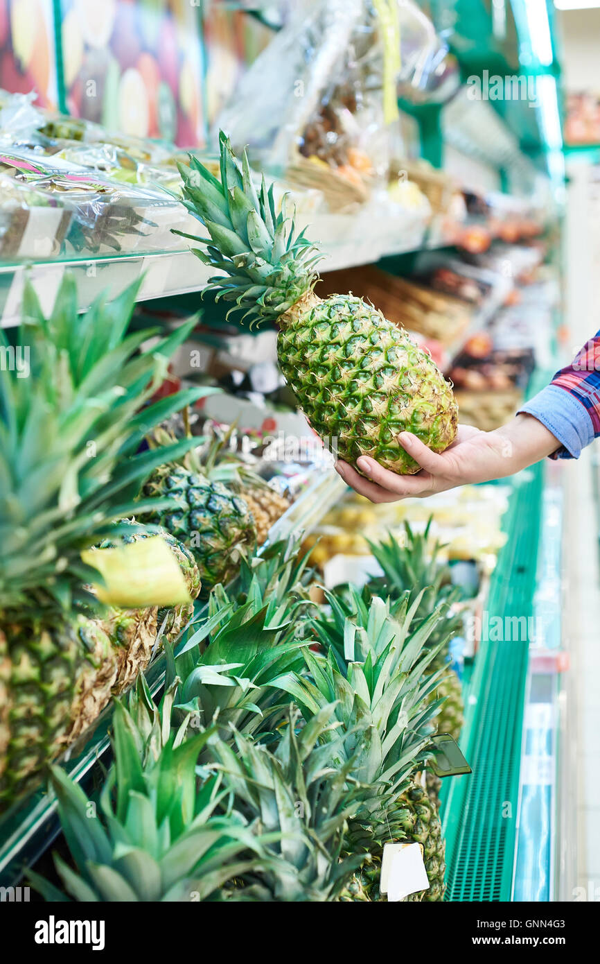 Buyer with pineapple in the store Stock Photo Alamy