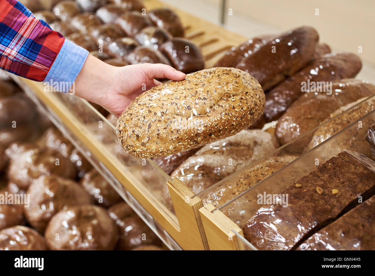 Buyer with a bread in the shop Stock Photo