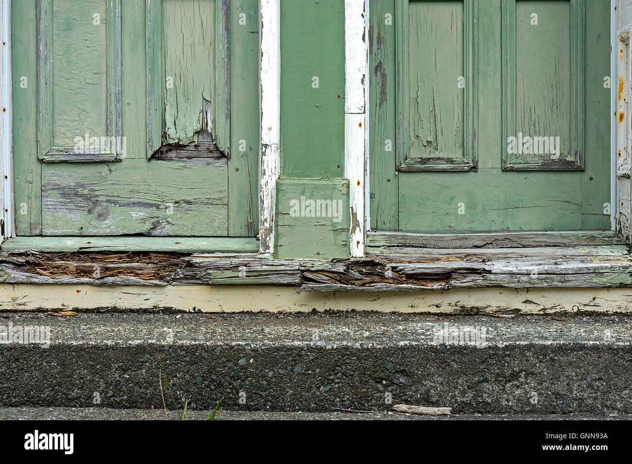 Rotten Door Frame Under Well Worn Green Doors Stock Photo