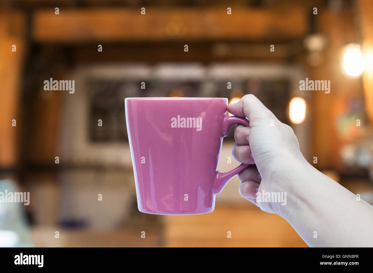 https://c8.alamy.com/comp/GNNBFR/woman-hand-holding-coffee-cup-in-coffee-shop-blurred-abstract-background-GNNBFR.jpg