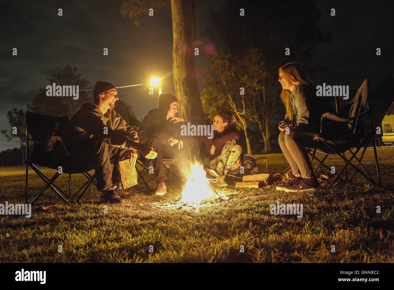 Friends making fire on a Campground near Brisbane - Australia Stock Photo