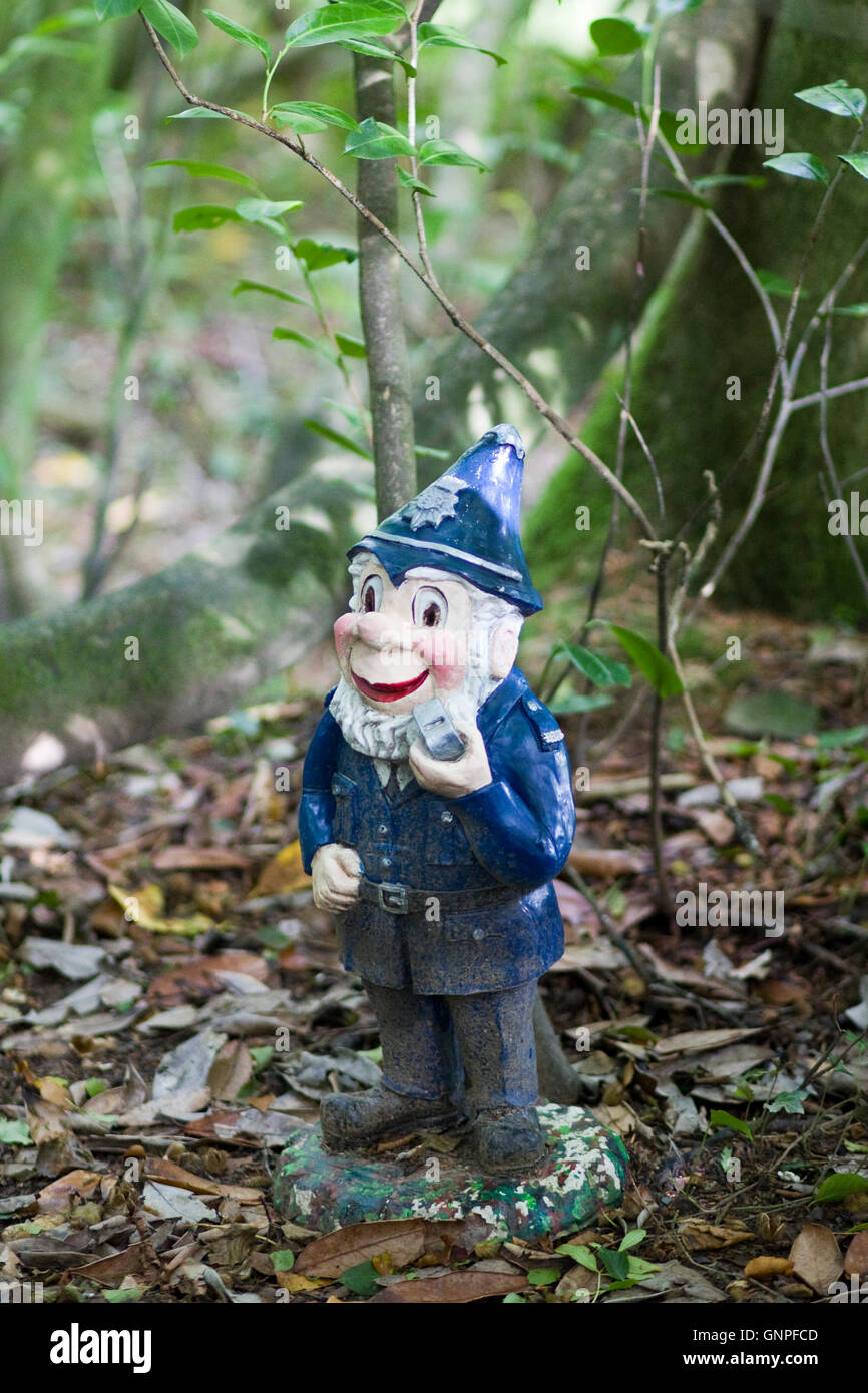 Old policeman garden gnome in the woodland Stock Photo