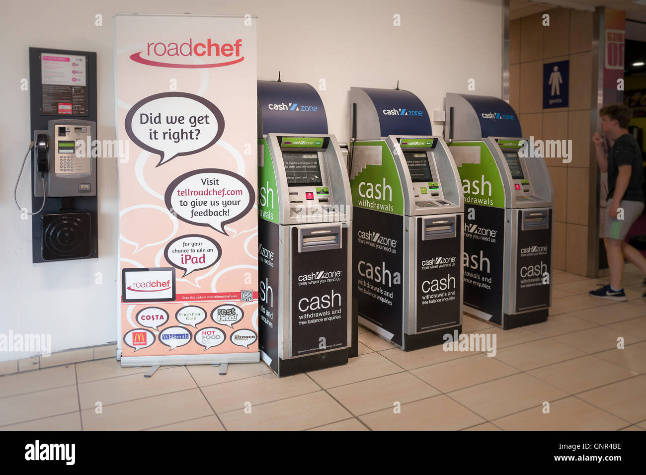 Inside a roadchef service station showing cash machines and a request for customer feedback to improve their services Stock Photo
