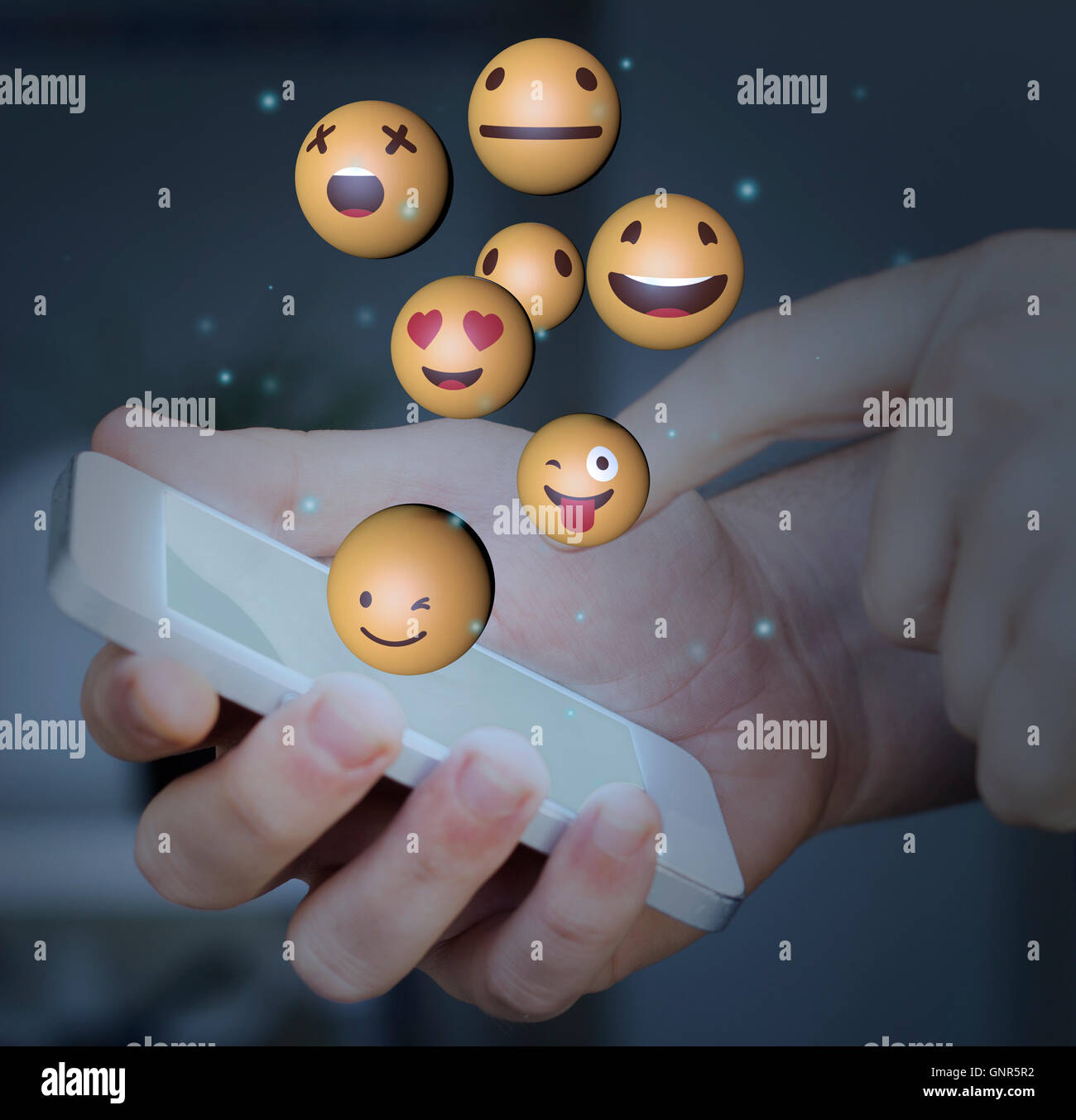 Finger touching a smartphone screen with emoji icons Stock Photo Alamy