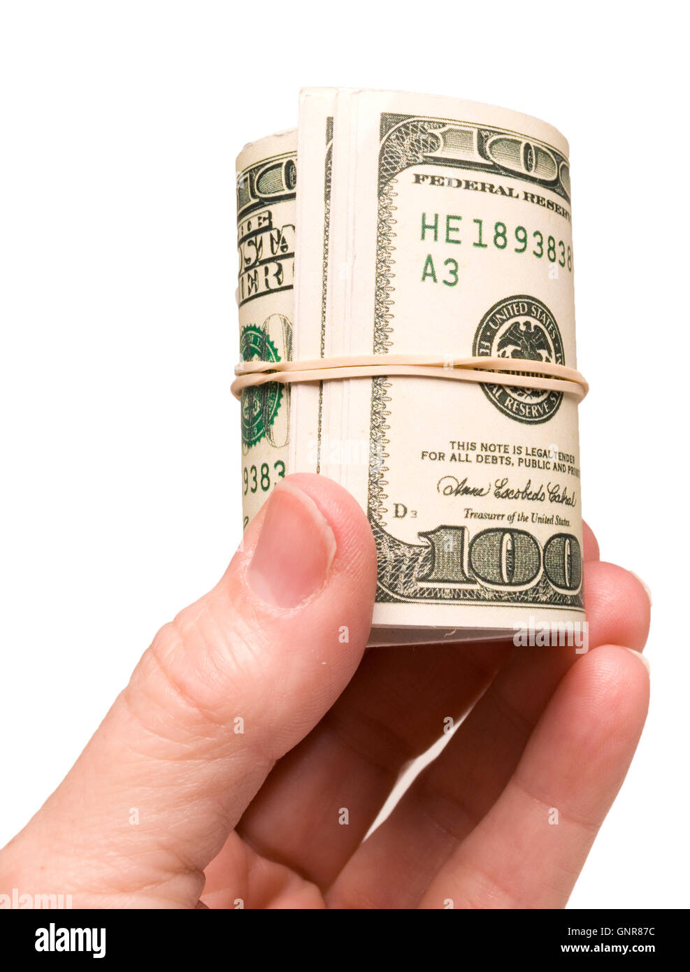 Hand Holding Roll Of Money Close Up Stock Photo