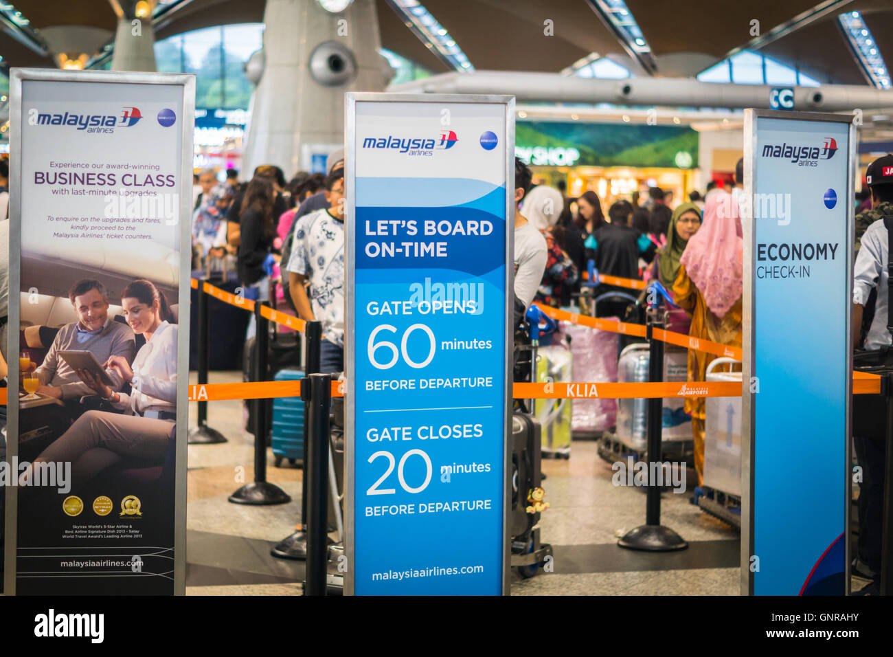 Kuala Lumpur, Malaysia - circa August 2016: Passengers at Malaysian Airlines check-in counter Kuala Lumpur international airport Stock Photo