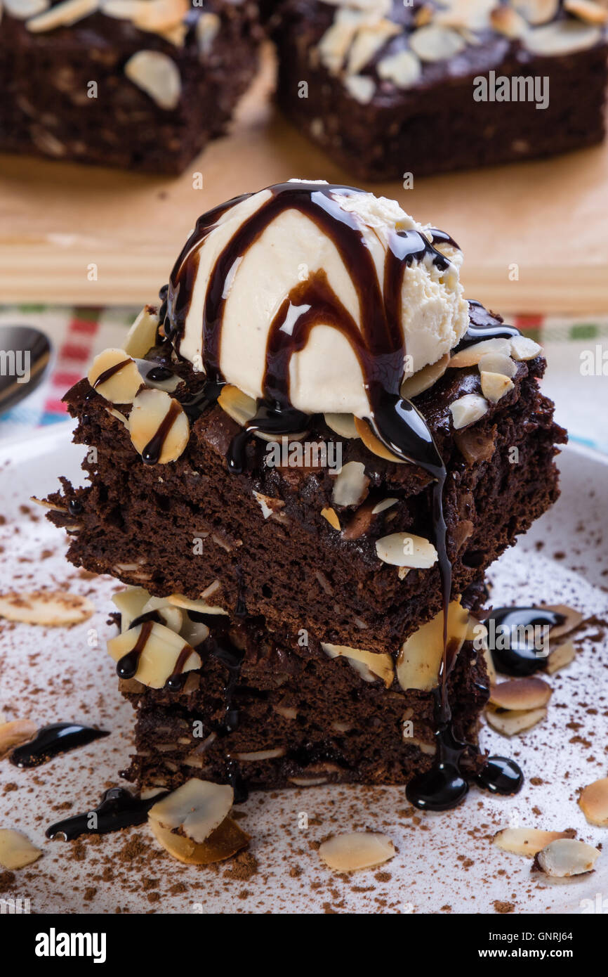 dark brownies with vanilla ice cream on white plate Stock Photo - Alamy
