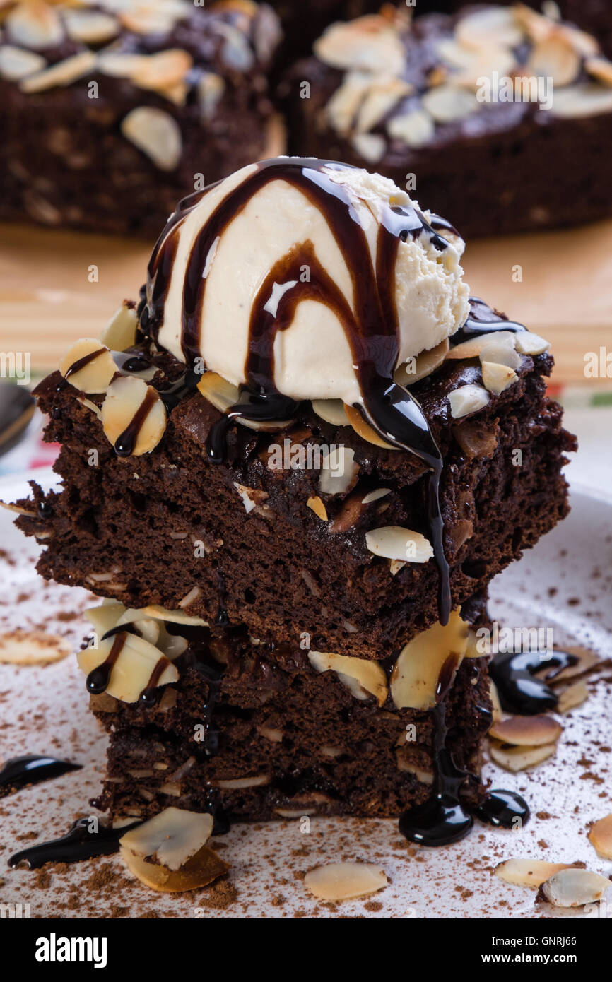 dark brownies with vanilla ice cream on white plate Stock Photo - Alamy