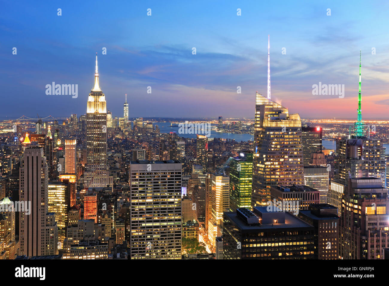 New York City skyline illuminated at dusk, USA Stock Photo