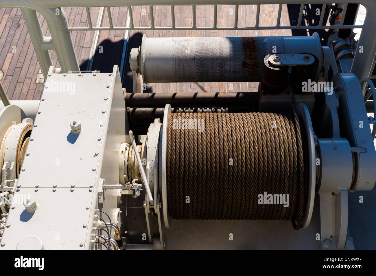 Large spool with steel wire on a tugging winch on a ship Stock Photo