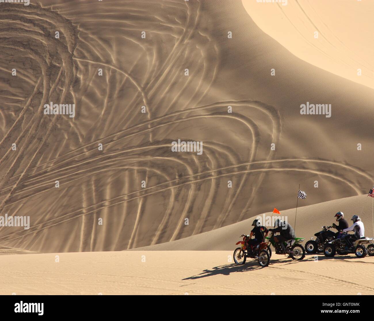 Off road enthusiasts prepare to ride dirt bikes and 4wheelers down a