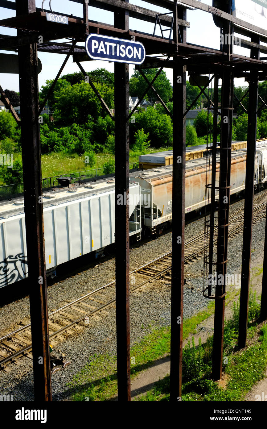 Freight cars viewed through metal railings in London, Ontario in Canada. Stock Photo