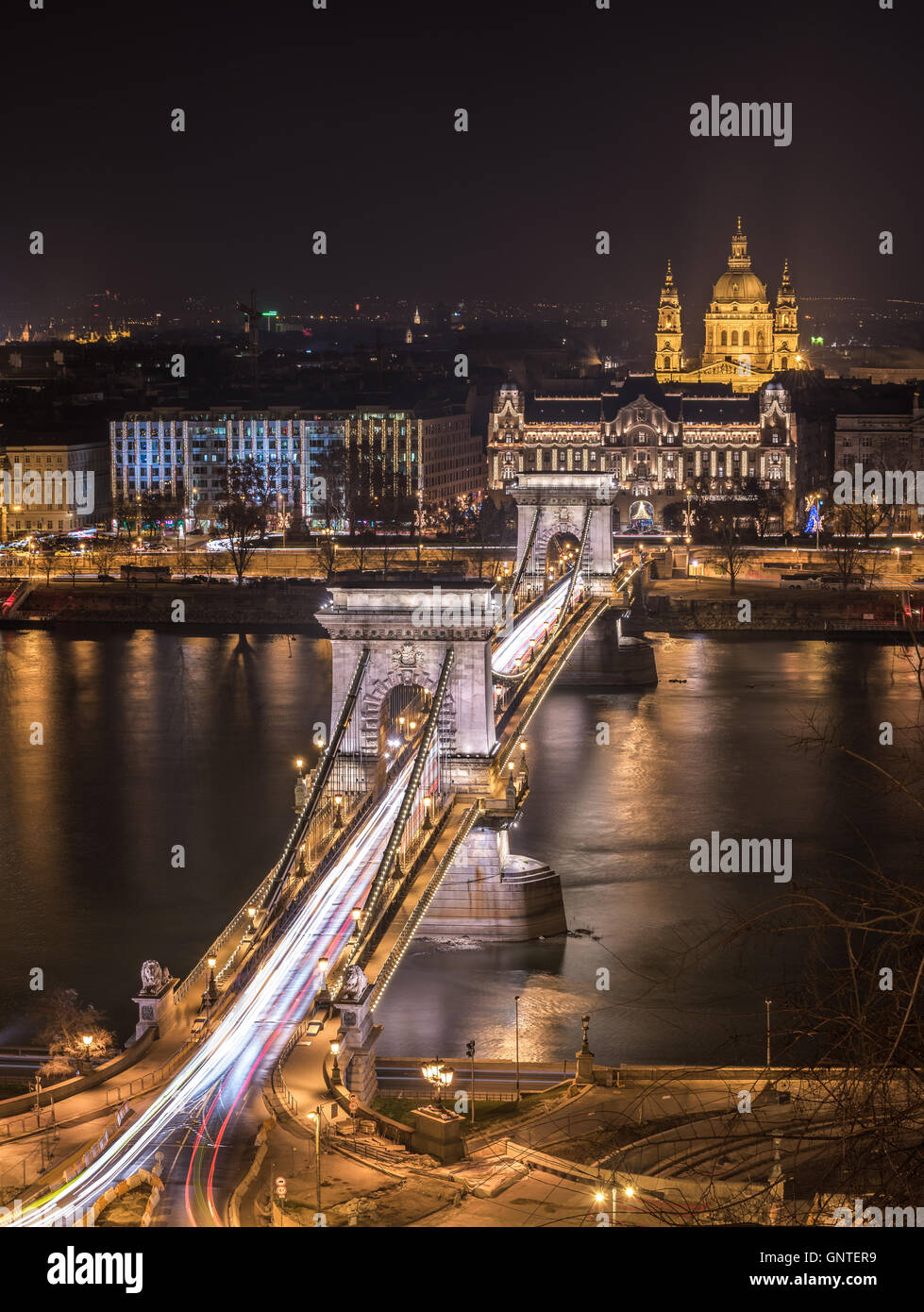 Night View of Chain Bridge over Danube River and St. Stephen's Basilica in Budapest, Hungary. As Seen from Royal Palace in Buda  Stock Photo