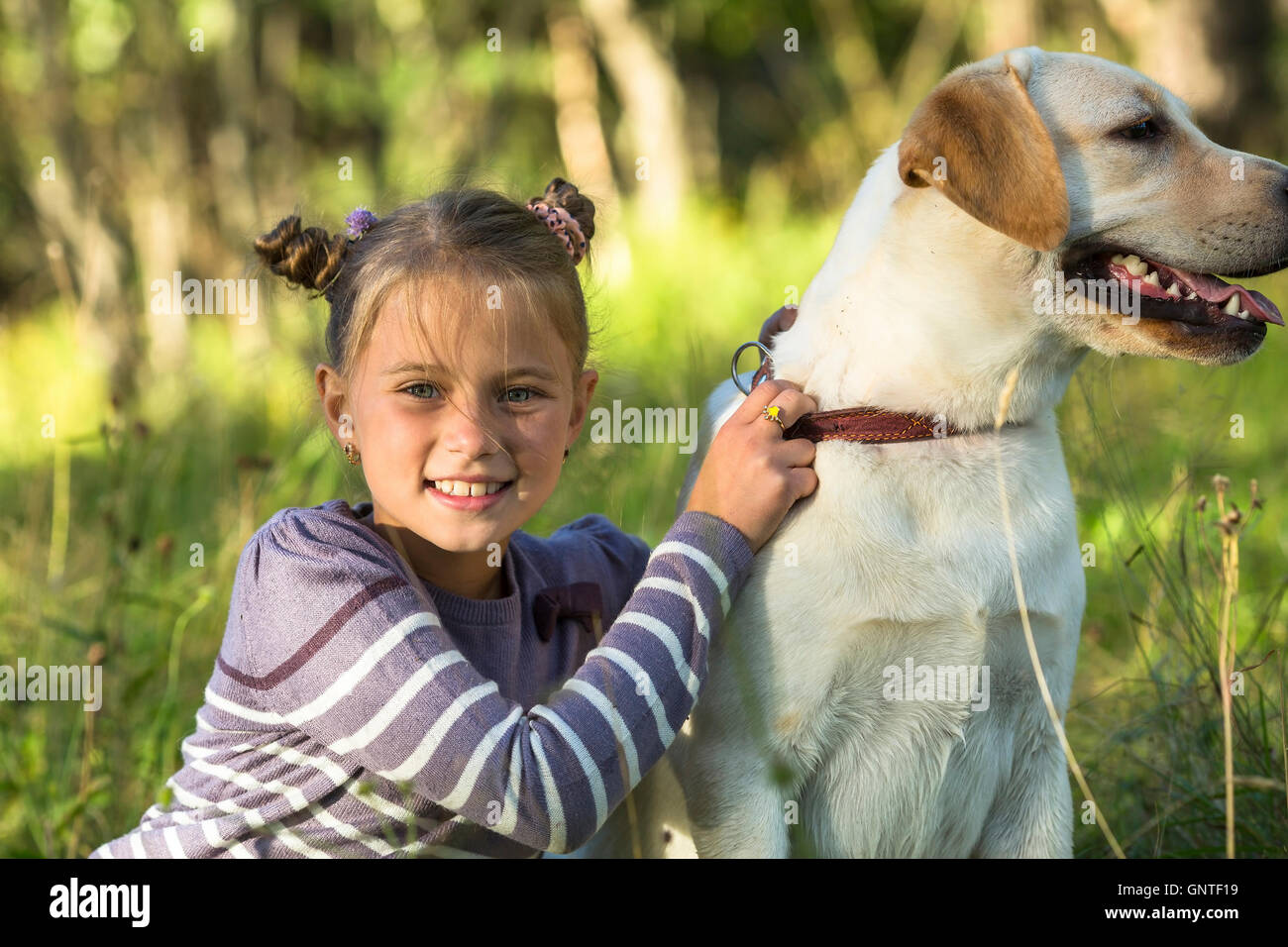 Portrait of a little girl with a dog Stock Photo - Alamy