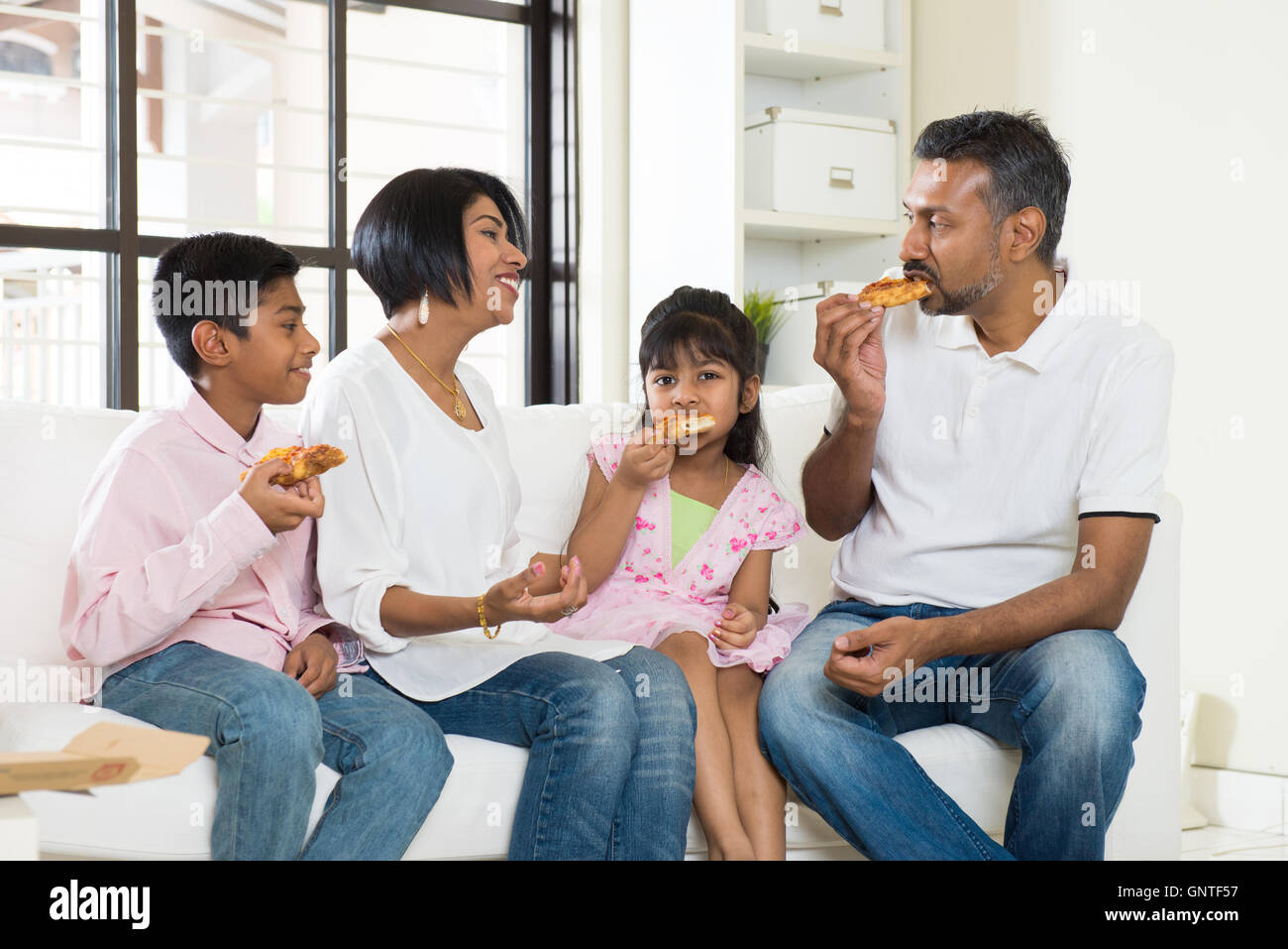 Indian family eating pizza hi-res stock photography and images - Alamy