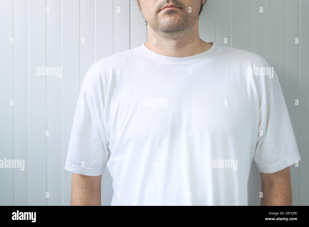 Casual adult male wearing blank white t-shirt as copy space for graphic design mock up Stock Photo
